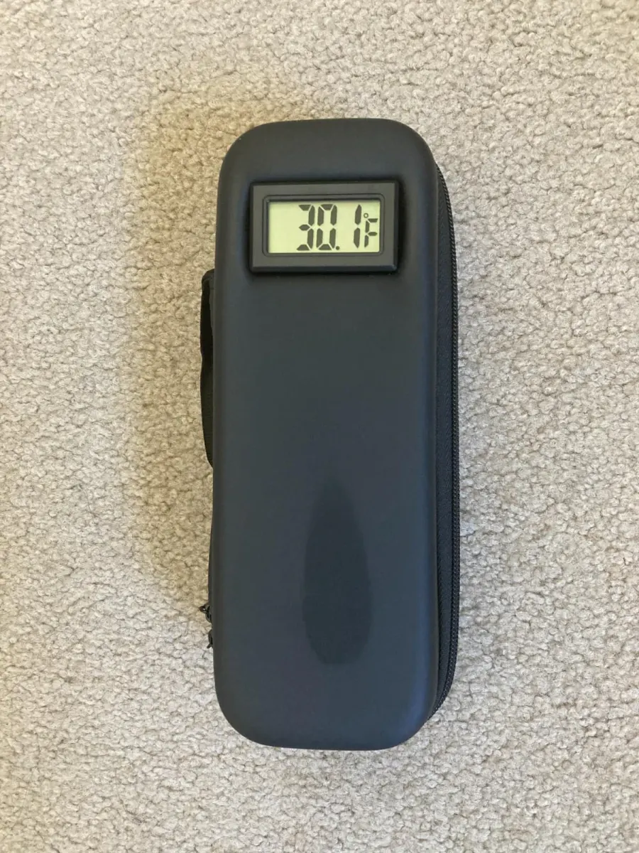 Customer photo: the black case on a carpet, its display reading 30.1°F